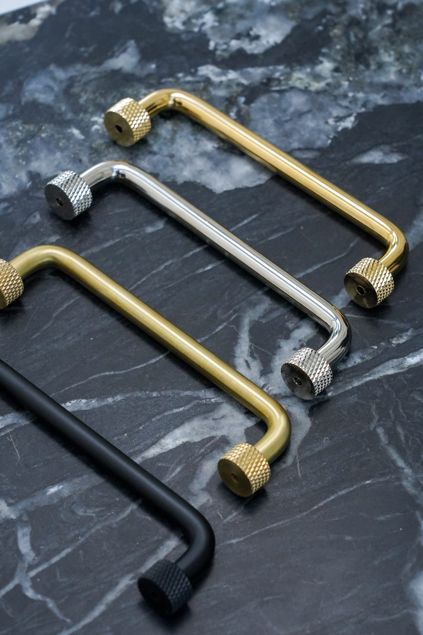 Køkkengreb i massiv messing uden lak. Grebet har runde fødder med riflet diamond cut mønster, som matcher til quooker armatur.